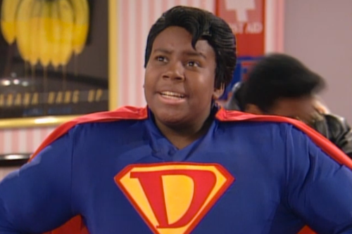 A young Kenan Thompson wears a Superman-like suit with a D on the chest.